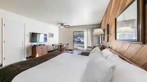 A hotel room with a large bed, a desk with chairs, a television, and a view of the outside. - 135 Bldg C 1 Bedroom Condo (Truckee)