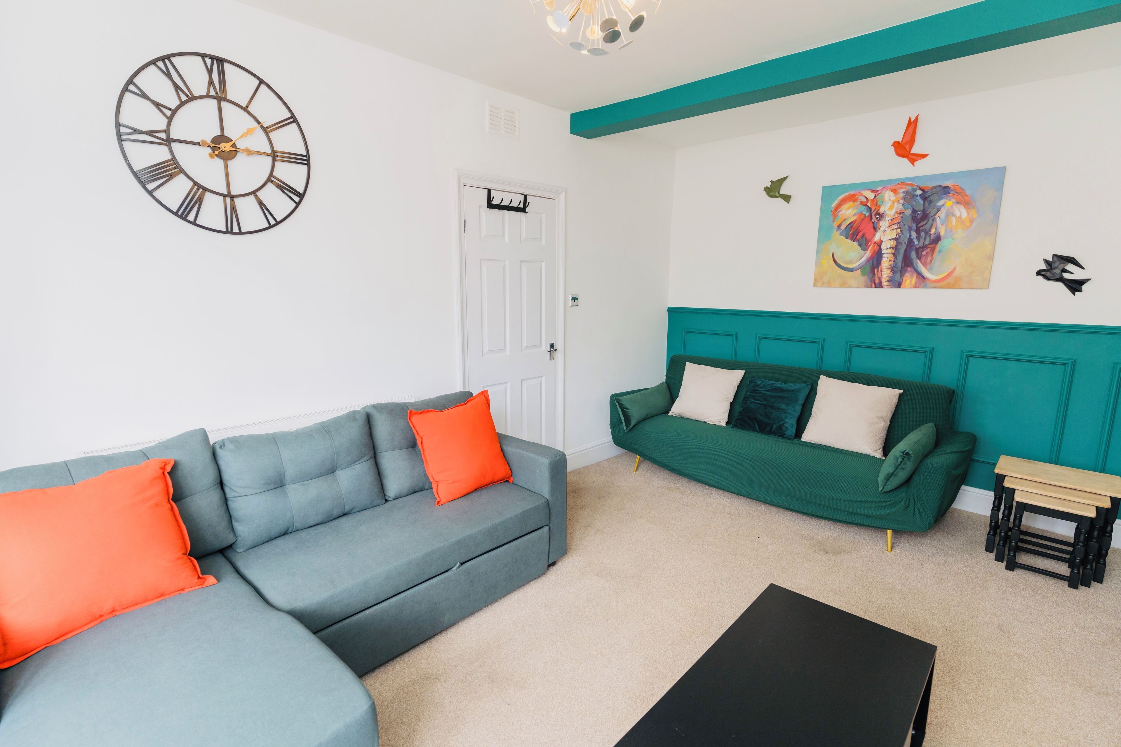 Green 3 seater click clack sofa & offers 45 degrees - great for movie night!