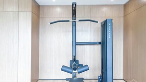 Une salle de sport équipée d’une barre de traction et d’une pile de poids de la marque MATRIX.