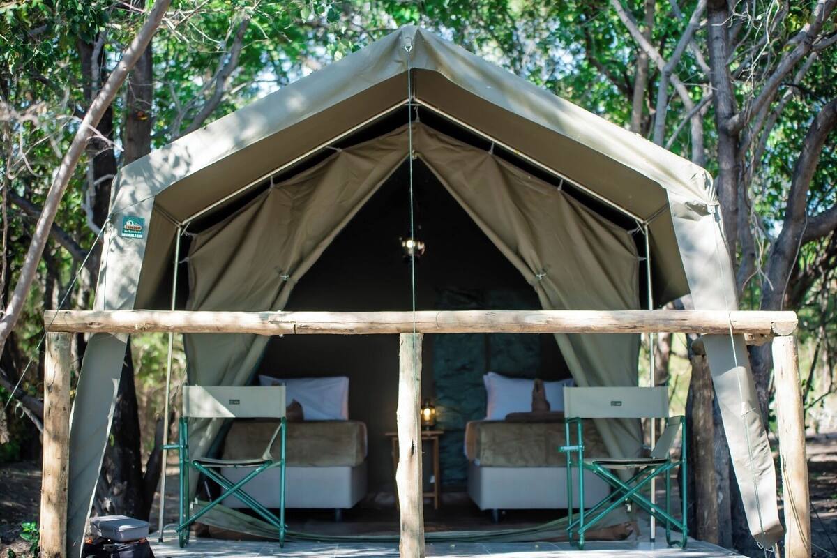 A tent with a simple layout, including two beds and a table.