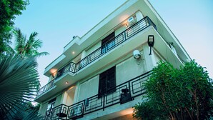 A multi-story building with balconies and outdoor lighting.
