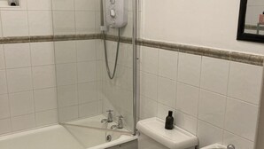 A bathroom with a bathtub, toilet, and sink. - City Centre Location - Sleeps 6 (Galway)