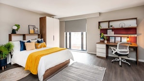 A modern bedroom with a bed, a desk, and a chair. - Zinc Works (Bristol)