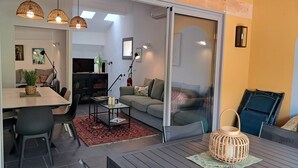 A modern living space with a dining area, a sofa, and a coffee table. - Hinterland, 35 minutes from Nice, air-conditioned duplex, sleeps 6 from 2 nights (Bouyon)