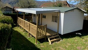 Une petite cabane à un seul étage, dotée d’un porche et d’un espace extérieur abrité.