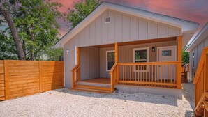 A small, single-story building with a wooden deck and a covered porch. - Your Amazing 3BR/2BA Downtown Delight! (San Antonio)