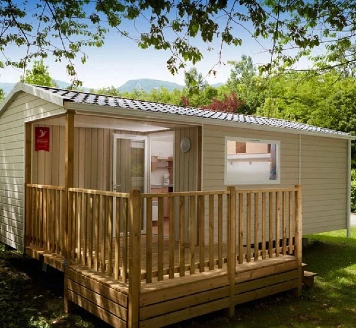 Une petite cabane en bois d’un seul étage, dotée d’un porche clôturé, d’une porte donnant sur l’intérieur et d’une fenêtre sur le côté.