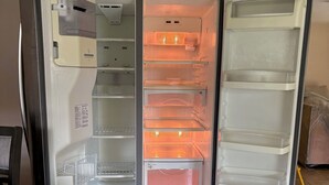 An open refrigerator with multiple shelves and compartments.