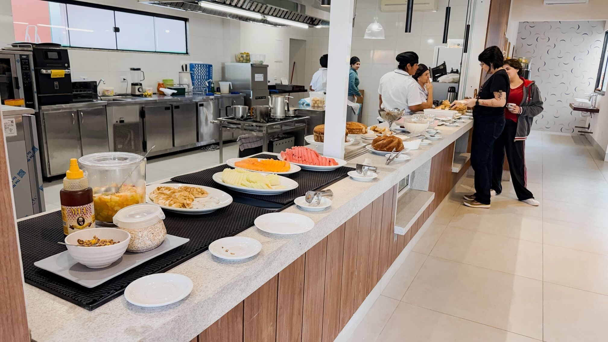 A buffet setup with various food items and a serving counter.