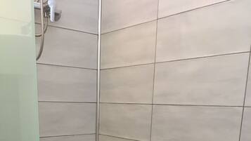 Shower, hair dryer, towels, toilet paper