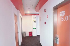 A corridor with a door marked '5.01' and a red trash bin. - Dingding Hotel (Shanghai Pudong Airport Heqing Town) (Shanghai)