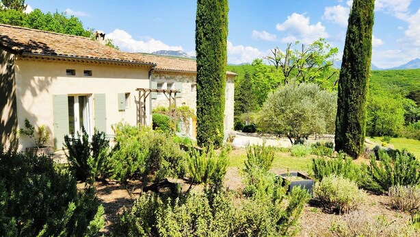 A rustic house with a tiled roof, surrounded by lush greenery and tall cypress trees. - Domaine de la Pigne, tranquillity as far as the eye can see (Puy-Saint-Martin)