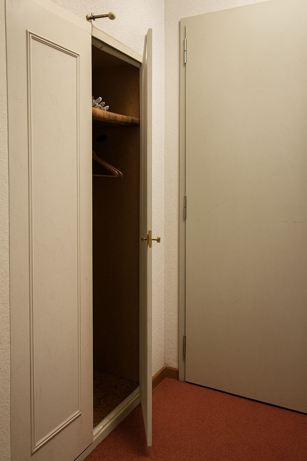 A closed door with a white frame and a visible handle.