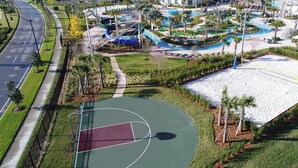 An aerial view of a resort with a basketball court, swimming pool, and landscaped areas. - 2 Bedrooms Apartment  in Storey Lake (Kissimmee)