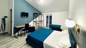 A bedroom with a bed, a desk, a chair, a TV, and a wardrobe. - Nautilus B & B  (Scalea)