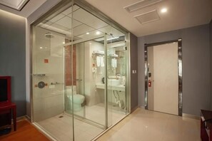 A modern bathroom with a glass-enclosed shower, a toilet, and a sink. - Rujia Pebble Hotel (Baoying Anyi East Road, Baoying Yangzhou) (Baoying)