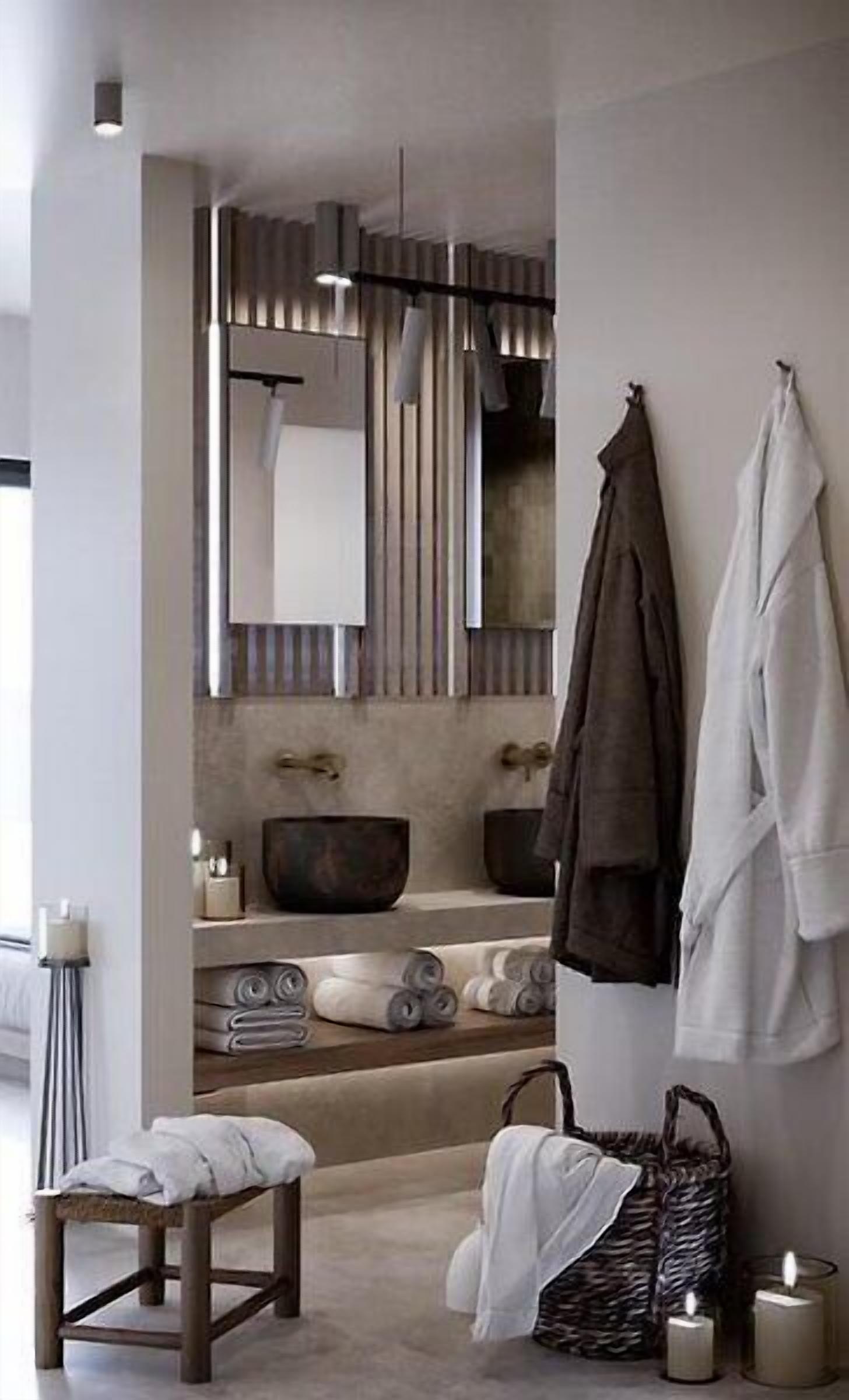 A modern bathroom with a large mirror, towel rack, and a bench.