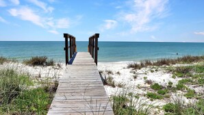 A wooden boardwalk leading to a beach with clear skies. - Sailor's Dream (Port St. Joe)