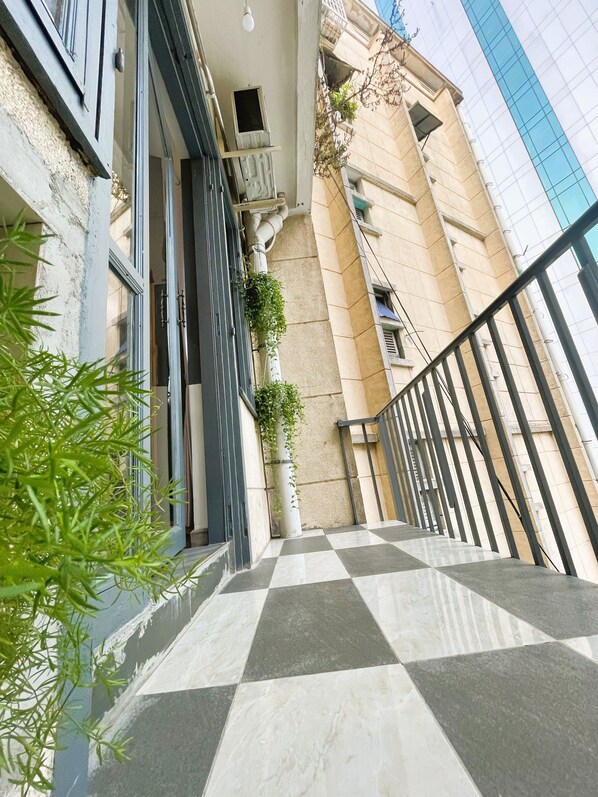 Deluxe Studio Suite, 1 King Bed, Balcony, City View | Balcony - The Cafe Apartment Building (Ho Chi Minh City)