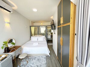 Deluxe Studio Suite, 1 King Bed, Non Smoking, City View | In-room safe, desk, laptop workspace, blackout curtains - The Cafe Apartment Building (Ho Chi Minh City)
