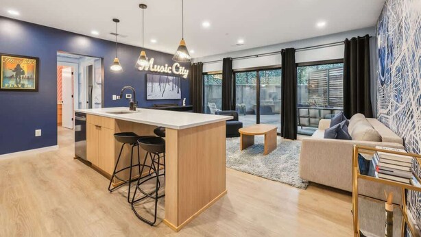 A modern living room with a central island, a sofa, and a coffee table.