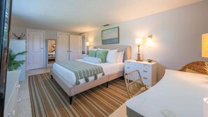 A bedroom with a bed, bedside tables, a chair, and a desk. - Sarasota Pool Home| Hot-tub| 2-miles to Siesta (Sarasota)