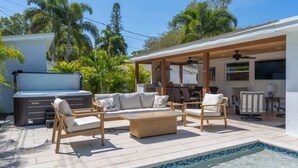 A poolside area with a hot tub, outdoor seating, and a covered patio. - Sarasota Pool Home| Hot-tub| 2-miles to Siesta (Sarasota)