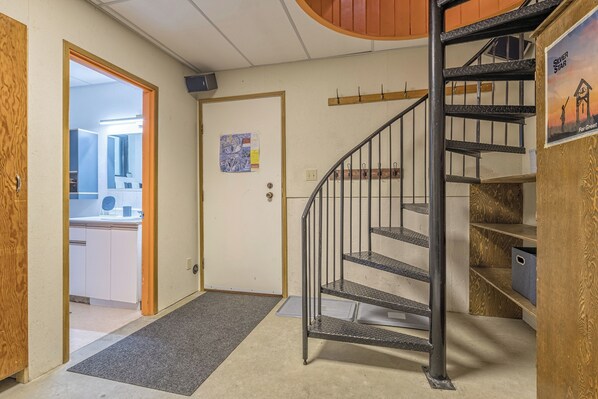A staircase with metal railings leading to a landing.