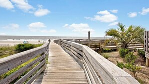 A wooden boardwalk leading to a beach with a clear sky and a few clouds. - Welcome to Coastal Calm at Bridgewater 
Oceanfront at LBTS at Pawleys Island (Pawleys Island)