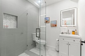 Shower, hair dryer, towels, toilet paper