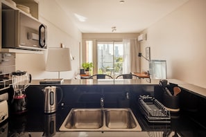 Comfort Apartment, City View | Private kitchen | Microwave, oven, stovetop, coffee/tea maker