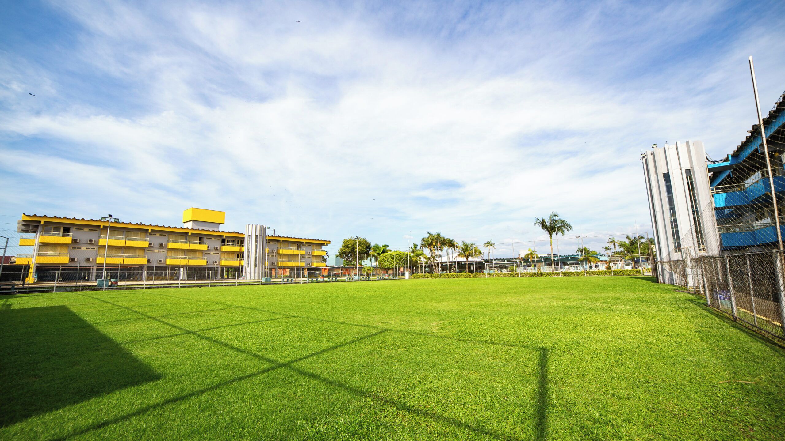 Un campo sportivo con un edificio sullo sfondo.