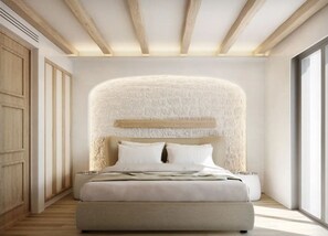 A modern bedroom with a large bed, a textured wall behind the bed, wooden beams on the ceiling, and a large window on the right. - Arocaria Hotel (Mykonos)