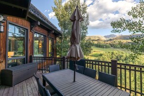 A wooden deck with outdoor furniture and a view of a mountainous landscape. - Vista Haus at Country Club - golf and ski retreat! (Mountain Village)