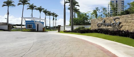 A paved pathway leading to a building with a sign that reads "Anisa."