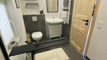 Shower, hair dryer, towels, toilet paper