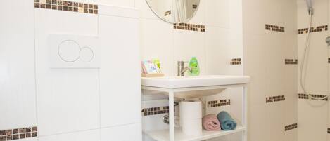 Shower, hair dryer, slippers, towels