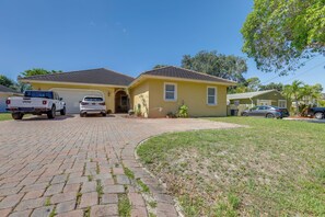 A two-story house with a garage, a driveway, and a lawn. - 5 Mi to Jupiter Beach Park: Poolside Oasis! (Jupiter)