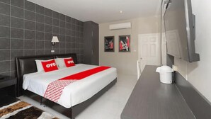 A modern hotel room with a large bed, a flat-screen TV, a desk, and a coffee maker. - Highway Hotel (Hua Hin)