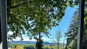 A gazebo with two white chairs overlooking a lake and forest. - Cozy 2-bedroom mobile home in front of lake pleasant. (Beaver)