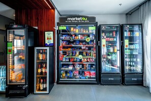 A row of refrigerated beverage dispensers with a sign above them.