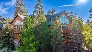 A lodge with a prominent wooden exterior, large windows, and a balcony.