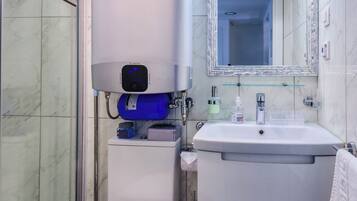 A modern bathroom with a toilet, sink, and shower.