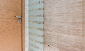 A wooden door with a glass panel and a metal handle.