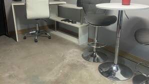 A small office with a white desk, a white chair, a round table with a red cup, and a globe on the desk. - Lovely 2-bedroom room rental in Blue Springs (Blue Springs)