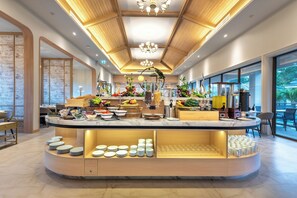 Un buffet de petit-déjeuner moderne proposant une grande variété de fruits, de boissons et de plats.