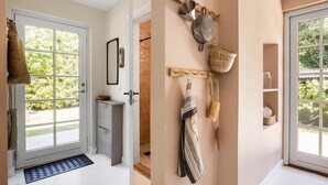 A hallway with a door leading to a patio, a wall-mounted drying rack, and a small shelf with a jar. - Lovely home in Tranekær with WiFi (Tranekær)