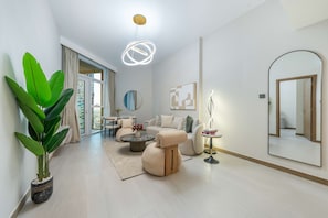 A modern living room with a sofa, coffee table, and a potted plant.