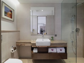 A modern bathroom with a large mirror, a sink, a shower, and a toilet. - W Residence Living (Dhaka)