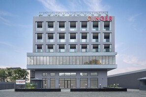 A modern building with a flat roof, large windows, and a prominent "GINGER" sign on the top. - Ginger Udaipur, Shastri Circle (Udaipur)